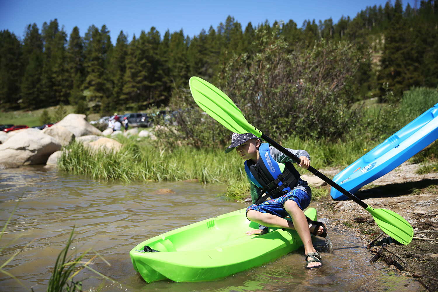 Jory Pierson balances his kayak as he climbs in on the edge